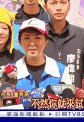 a woman wearing a pokemon hat is holding a poke ball