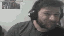 a man with a beard wearing headphones looks at the camera .