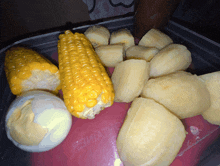 corn on the cob bananas and hard boiled eggs in a container