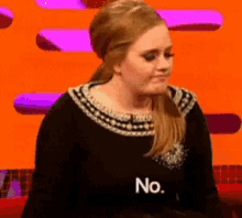a woman is wearing a black shirt with the word no on it