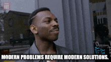 a man standing in front of a building with the words modern problems require modern solutions written below him