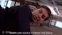a man is laying on the floor with the words `` when she sucks it from the back '' written above him .