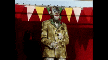 a statue of a clown wearing a yellow suit and tie
