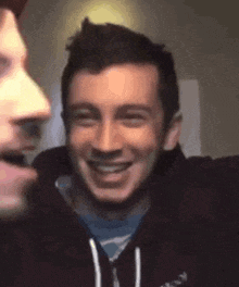 a man is taking a selfie with another man while another man looks on .