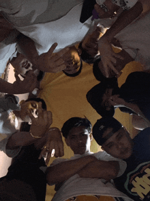a group of young men are posing for a picture and one of them is wearing a shirt that says abercrombie & fitch