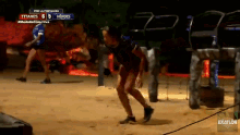 a woman is running on a dirt field with a score of 6 to 5