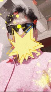 a man wearing sunglasses and a pink shirt is surrounded by a yellow star