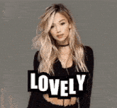 a woman in a black crop top with the word lovely behind her