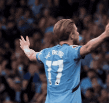 a soccer player in a blue jersey with the number 17 on it