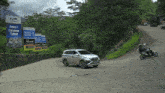 a car is driving down a road next to a sign that says ptt