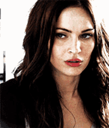 a close up of a woman 's face with a serious look on her face
