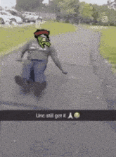 a pixelated image of a person sliding down a road with the caption unc still got it