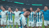 a group of soccer players wearing blue and white striped uniforms with the number 26 on their shorts