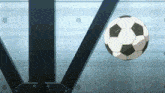 a soccer ball is flying through the air in front of a blue wall