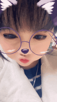 a young girl wearing glasses with a cat nose