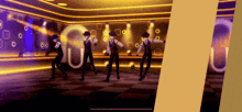 a group of men are dancing in a room with the letter u in the middle