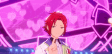 a boy with red hair is giving a peace sign in front of a purple background with hearts .