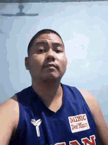 a man is wearing a blue shirt that says mrbc on it