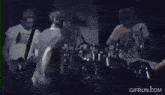 a group of people are playing instruments on stage .