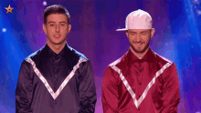 two men are standing next to each other and one has a white hat on