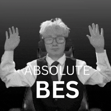 a black and white photo of a man wearing glasses and headphones with the words absolute bes above him