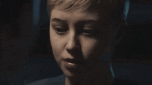 a close up of a person 's face with a dark background