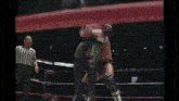 two wrestlers are fighting in a ring with a referee watching .