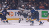a hockey game is being played in front of an nhl advertisement