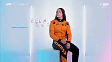 a young woman named ella lloyd is smiling and wearing an orange jacket