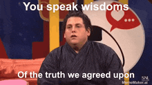 a man sitting on a couch with the words you speak wisdoms of the truth we agreed upon