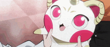 a person is holding a white and pink cartoon character with horns