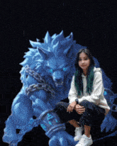 a girl is kneeling in front of a blue wolf with chains around its neck