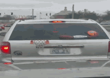 a silver van with a basketball hoop on the back and a license plate that says 269 ifx