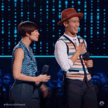 a man and woman are standing next to each other on a stage .