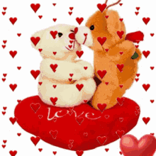 two teddy bears are kissing on a red heart shaped pillow that says love