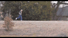 a man running on a hill wearing a t-shirt that says ' chicago bears ' on it
