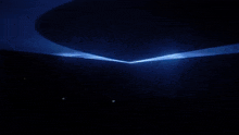 a dark room with a blue light coming out of the top
