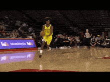 a basketball player wearing a yellow jersey with the number 1