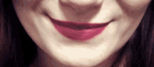a close up of a woman 's mouth with pink lipstick on it .