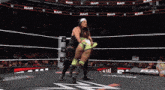 two women are wrestling in a ring with the word raw on the walls