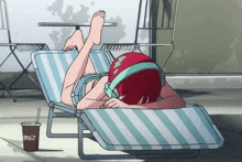 a person laying on a striped chair with a cup of coffee that says ' iced tea ' on it