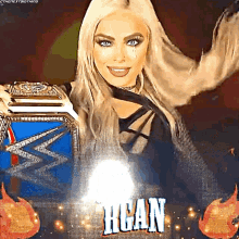 a woman is holding a wrestling championship belt and the word hogan is on the background