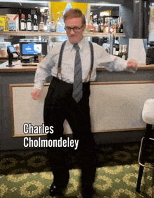 a man in a suit and tie is dancing with the name charles cholmondeley