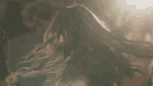 a woman with her arms in the air is dancing in a crowd
