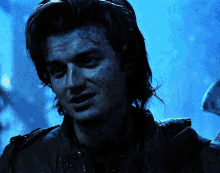 a close up of a man 's face with a dark background