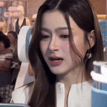 a close up of a woman 's face while sitting in a chair .