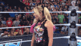 a woman in a wrestling ring with the letter w on the rope