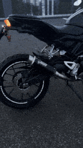a black motorcycle with the word akrapovic on the exhaust