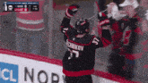 a hockey player in a black jersey with the number 37 on it