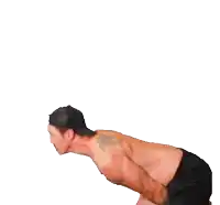 a shirtless man is swinging a yellow object